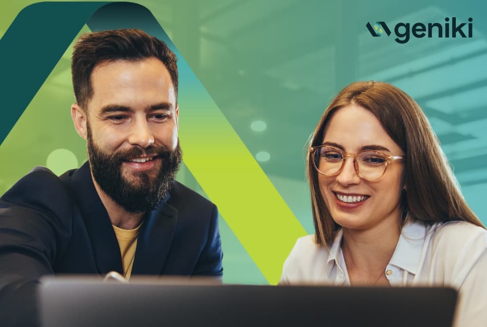 Two people sitting together behind a laptop.