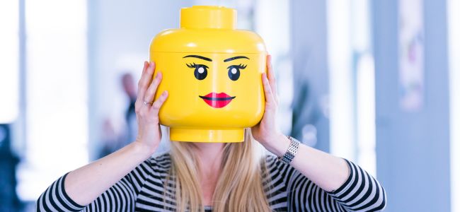 A photo of Marella Hesseling holding up a Lego head.